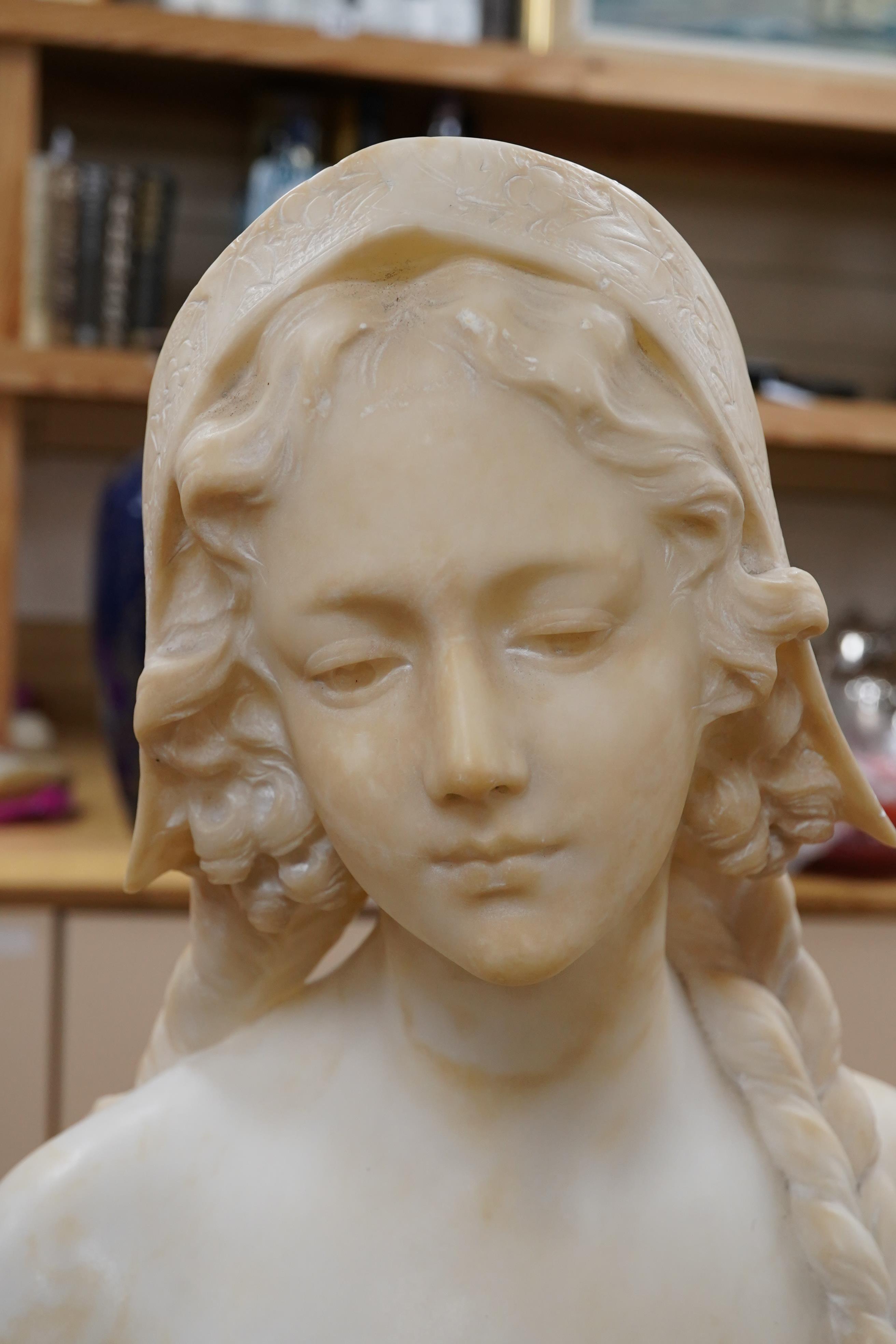 A French alabaster bust of a girl with long plait wearing a hat, signed on the back of pedestal, 54cm high. Condition - good